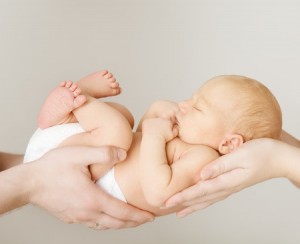 27462460 - baby newborn sleeping on parents hands, kid and family concept