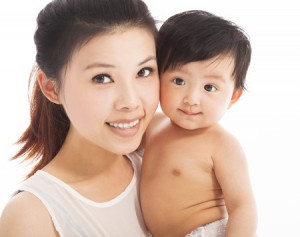 27868048 - happy  mother holding smiling child baby