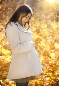 14634220 - happy pregnant woman in the autumn forest