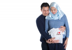 51185246 - young happy muslim pregnant couple over white background