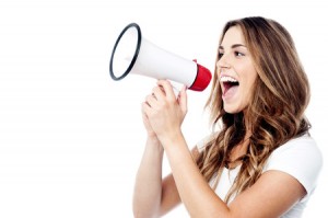 34073053 - woman making announcement with megaphone