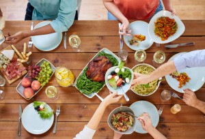 group of people eating at table with food