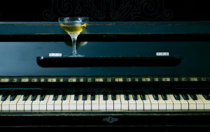 Alcoholic drink in glass on the piano