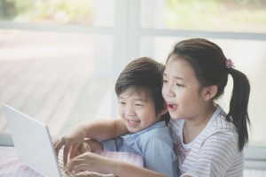 Asian children using tablet together
